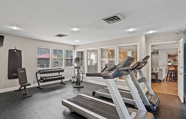 a gym with treadmills and other exercise equipment