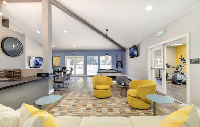 a living room with couches and chairs and a ping pong table at Renaissance Park Apartments, Davis, CA, 95618