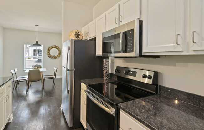 Ashland Farms Kitchen Open to Dining Room with Granite Counters, Full Appliance Package, and Ample Cabinet Storage