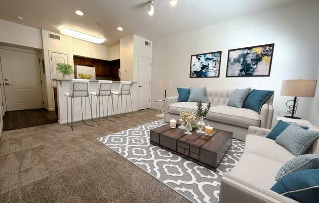 Liberty Landing Apartments Heathrow Floor Plan Living Room with couches, barstools and coffee table. West Jordan, Utah.