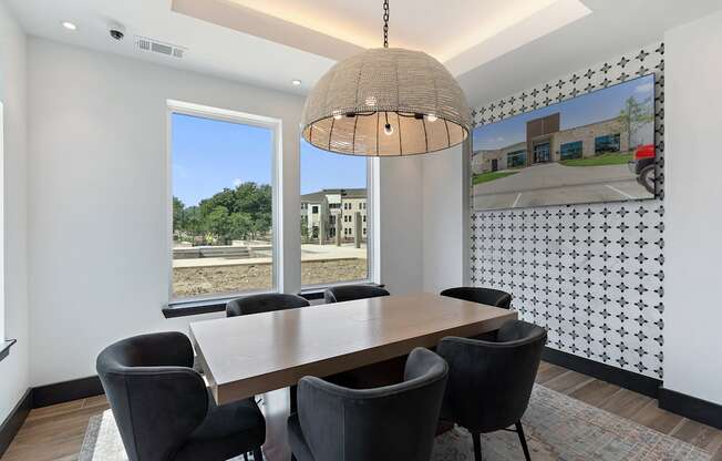 A dining room with a table and chairs.