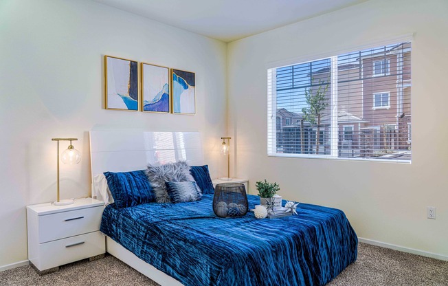 bedroom with carpeted flooring and bed with a blue comforter at Turtle Creek apartments