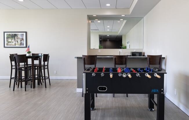 a game room with a pool table and a bar