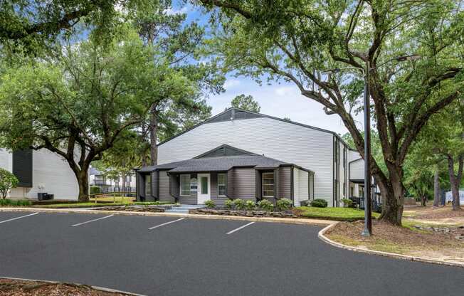 a large white building with a black asphalt road in front of it