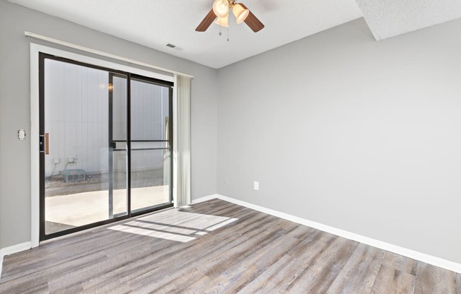 Living room with large patio door at Eddingham in Lawrence, KS