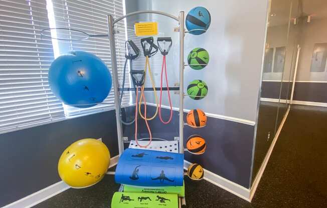 a fitness room with sports equipment and weights