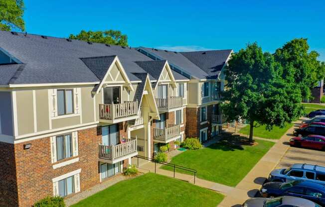 an aerial view of an apartment building with cars parked in front of it at Fairlane Apartments, Springfield, MI, 49037