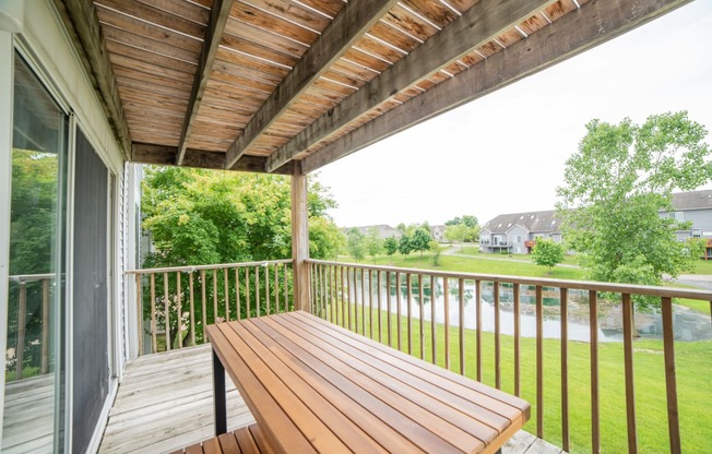 Balcony with a table and a great view at Cambridge Club apartments in Ann Arbor, Michigan