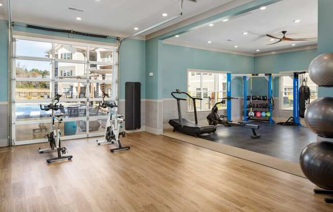 The Alexandria premium fitness center with exercise equipment and wood-designed flooring in Madison, AL