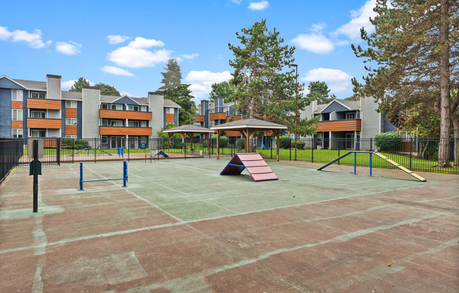 an empty playground with a slide and swings at an apartment complex