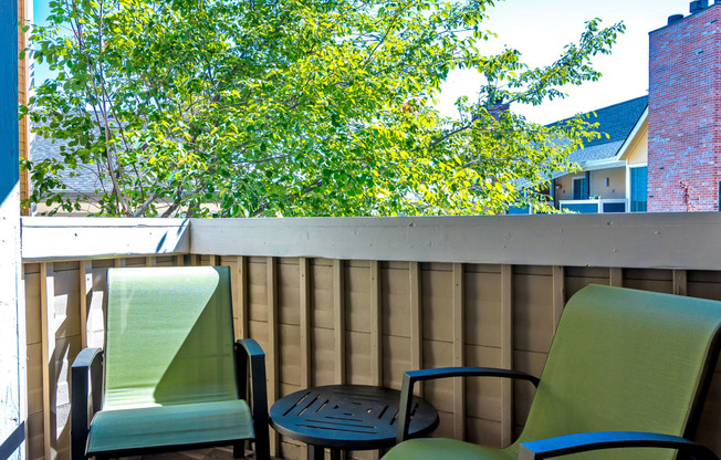 a patio with two chairs and a table on a balcony at Skyview Apartments, Colorado, 80234