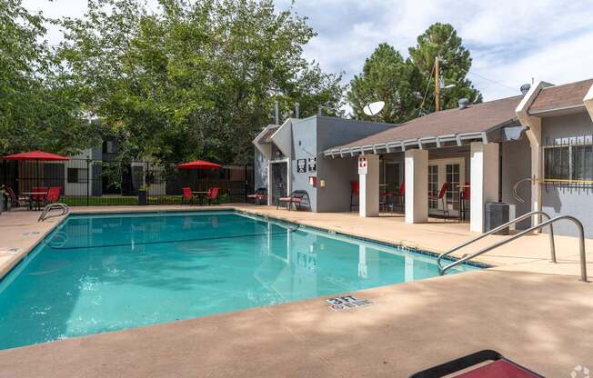 A swimming pool with a building in the background.