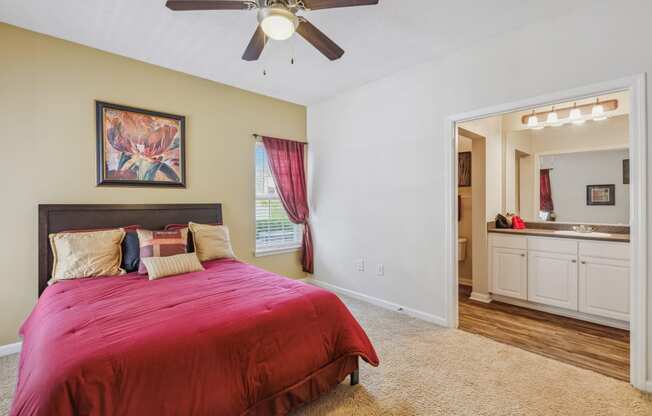 a bedroom with a bed and a ceiling fan