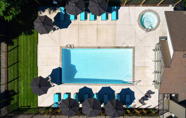 arial view of a pool with umbrellas and chairs