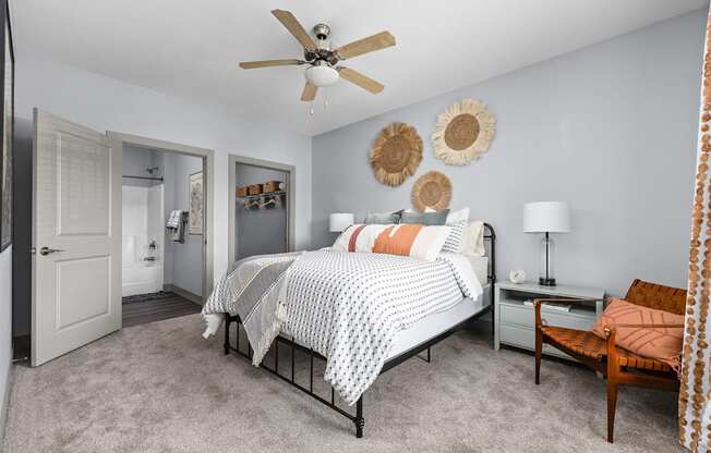 a bedroom with a bed and a ceiling fan
