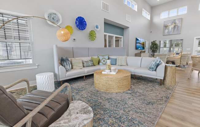 a living room with couches and chairs and a rug