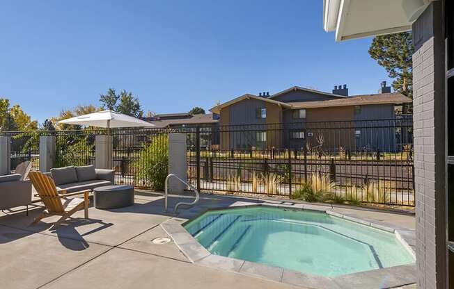 our apartments have a resort style pool with chairs and an umbrella