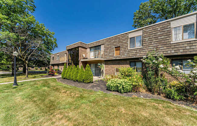 A building with a green lawn in front of it.