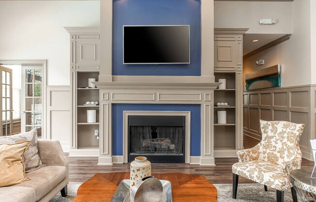 A living room with a fireplace and a television above it.