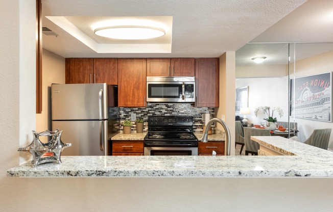 a kitchen with stainless steel appliances and granite counter tops