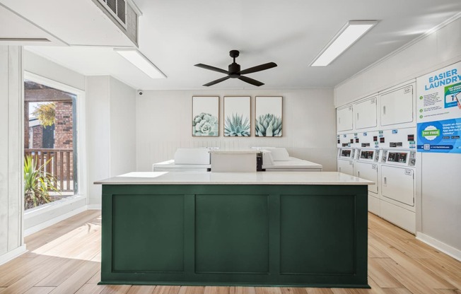 a kitchen with a green island and white cabinets