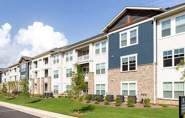 a row of apartment buildings on the side of a street at Promenade at Newnan Crossing, Newnan, GA 30265