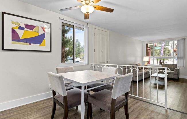 a dining room with a table and chairs and a ceiling fan