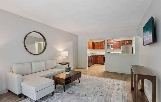 A living room with a white couch and a coffee table.