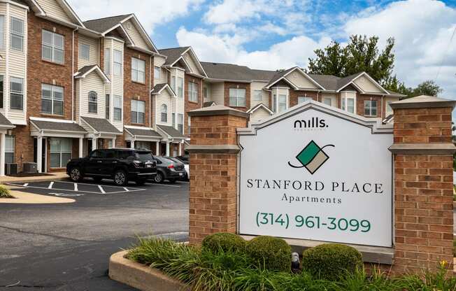 an apartment building with a sign for mills place apartments