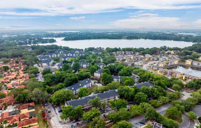 an aerial view of a neighborhood with a body of water