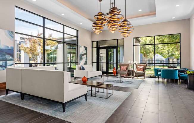 A modern living room with a large white sofa and a glass door.