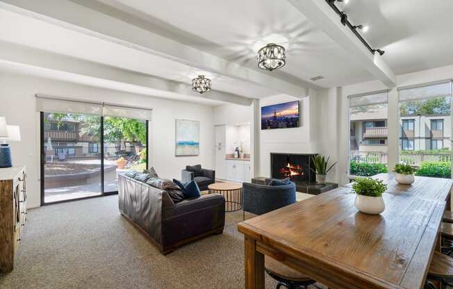 a living room with couches and a table and a fireplace