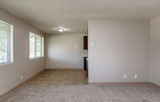 A room with a carpeted floor and a window.