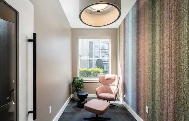 A hallway with a chair and a plant.