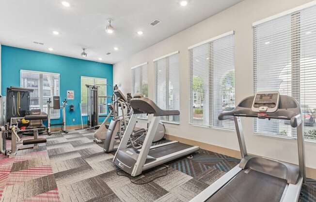 A gym with treadmills and other exercise equipment.