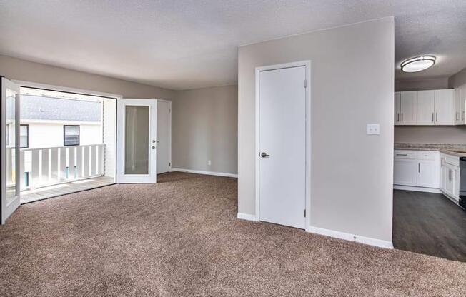 an empty living room with an open door to a kitchen at Cleo Apartments, Athens
