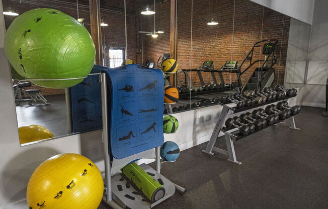 a fitness room with weights and other exercise equipment