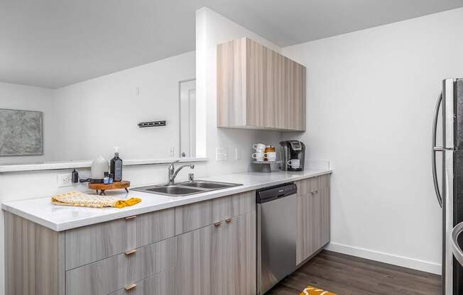 a small kitchen with a sink and a refrigerator