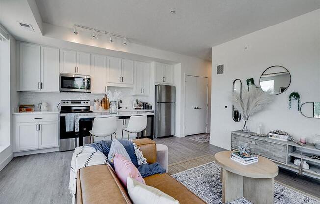 a living room with a kitchen and a couch
