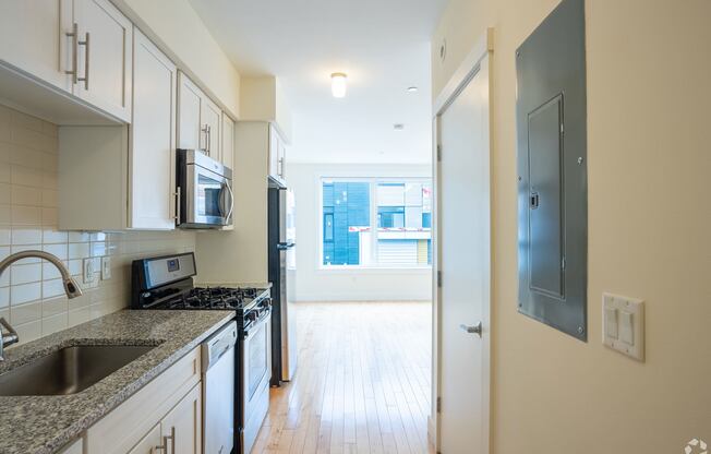A kitchen with a sink, microwave, and oven. at 603 Concord Apartments, Cambridge, MA