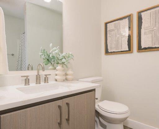 a bathroom with a toilet and a sink and a mirror