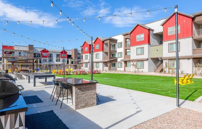 A sunny day at a colorful outdoor residential area with a picnic table and chairs.