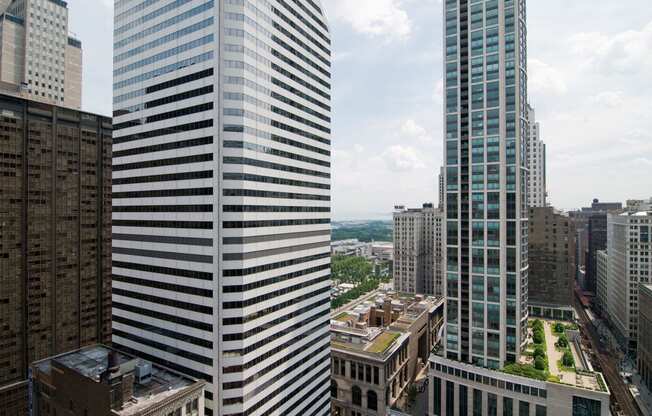 two tall skyscrapers with a city in the background