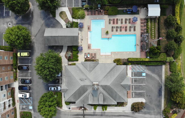 arial view of a building with a pool in the middle