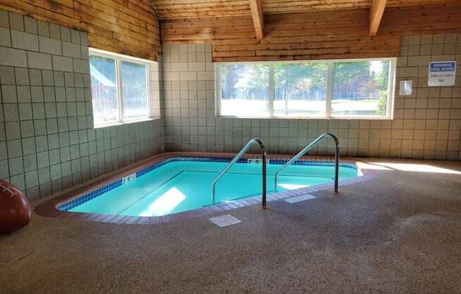 a swimming pool inside of a building with a pool