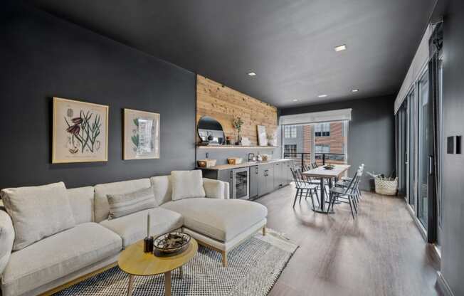 a living room with a couch and a table and a kitchen