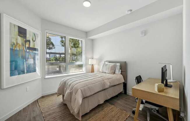 Bedroom with a desk and chair at Bayview Apartments, Emeryville