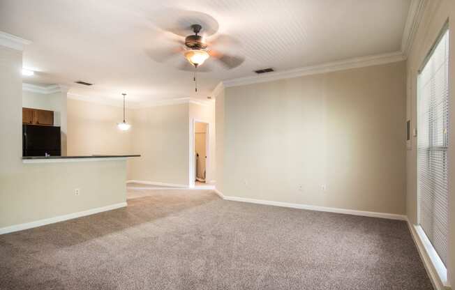 Spacious empty living room with carpeted floor at Angel Landing apartments in Pensacola, FL