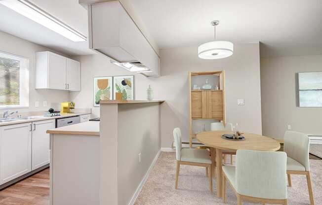 a dining room and kitchen with a table and chairs