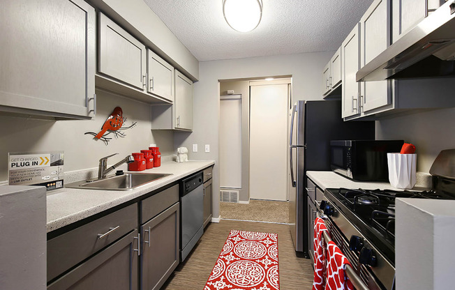 full kitchen with stainless steel appliances at the district flats apartments in lenexa